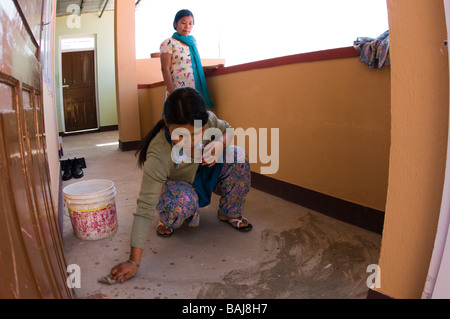 nepali girls cleaning and sweeping Stock Photo