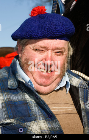 Man with blue woollen hat and red pom-pom at country fair in Ayrshire Scotland Stock Photo