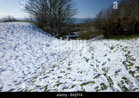 Snow in the Purbeck Hills looking down to Kimmeridge Bay Dorset, UK Stock Photo