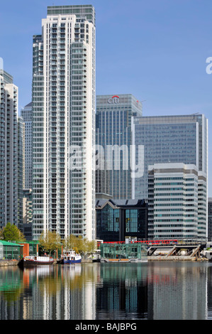 East London Docklands waterside high rise apartments flats development Millwall Docks Canary Wharf Citi bank office tower block & DLR train beyond UK Stock Photo