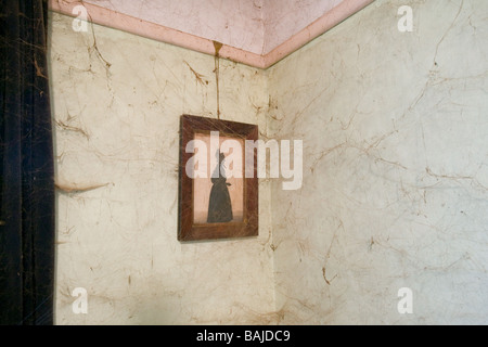 A framed photograph hanging on the wall in the room belonging to a single old man who hadn't dusted for more than 20 years Stock Photo