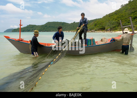 Fishermen catch fish near the shore using nets. Stock Photo