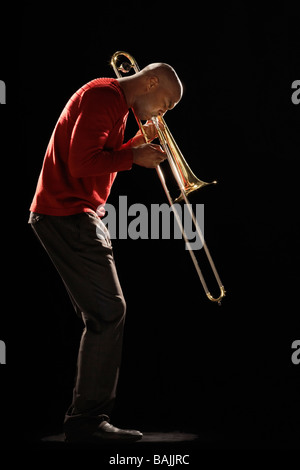 Man Playing Trombone, side view Stock Photo