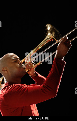 Man Playing Trombone, close-up, side view Stock Photo