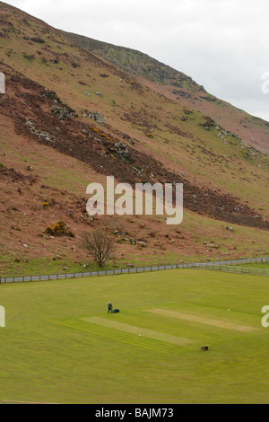 Groundsman preparing cricket pitch situated within rocks and hills, Valley of the Rocks, Lynton, North Devon. Stock Photo