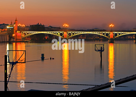Puente de Isabel II (bridge) across the Rio Guadalquivir (River) at dusk,City of Sevilla (Seville),Province of Sevilla,Andalusia Stock Photo