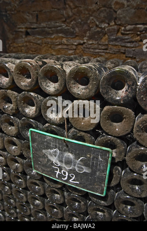 old bottles in the cellar chalk board domaine comte senard aloxe-corton cote de beaune burgundy france Stock Photo