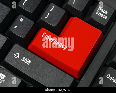 Closeup of computer keyboard key in red color spelling Emergency Stock Photo