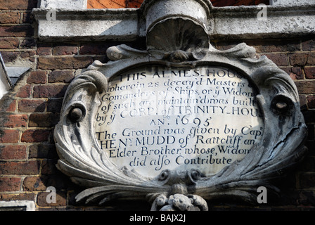 Stone plaque on exterior wall of Trinity Green Almshouses in Mile End Road Whitechapel London Stock Photo