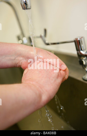 nurse washing hands correctly. Stock Photo