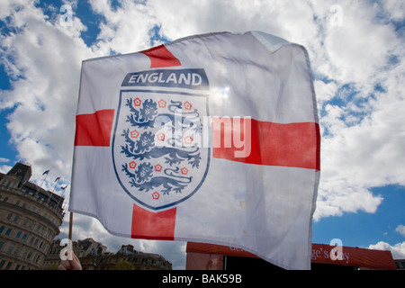 Backlit England flag being waved in Trafalgar Square during St George's Day celebrations. Stock Photo