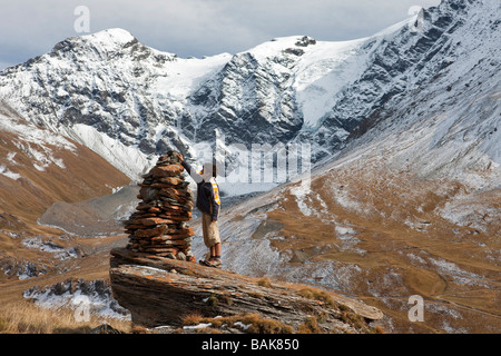 France, Savoie, Le Clou hamlet (2226m), piled stones on the way to the Clou Lake, the Pointe des Mines and the upper side of Stock Photo