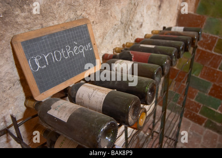 old bottles in the cellar chalk board mas du notaire rhone france Stock Photo