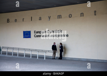 Two men in conversation in the shelter of buildings of the European Commission in Brussels Belgium Stock Photo