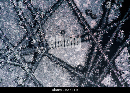 Frost crystals form patterns on a window pane Stock Photo