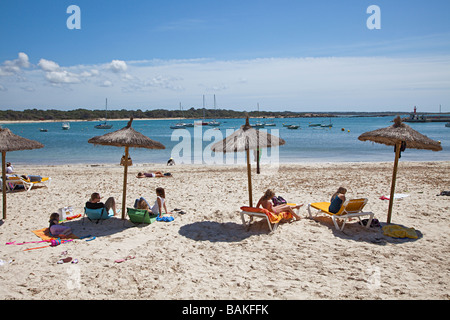 People under shade umbrellas on beach Colonia de Sant Jordi Mallorca Spain Stock Photo