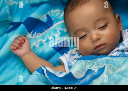 A sleeping five month old baby boy. Baby is half Asian and half Caucasian. Stock Photo