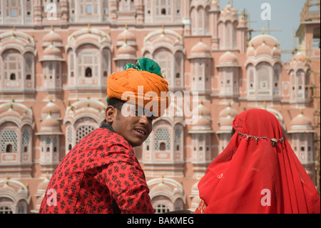 Young Indians in traditional clothing in front of the Hawa Mahal The Palace of Winds Jaipur India Stock Photo