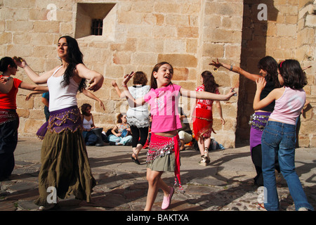 Young girl and adults at dance workshop at Woman festival in Caceres, Spain