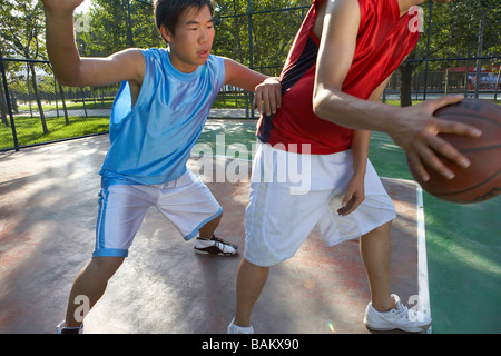 Young Men Playing Basketball Stock Photo