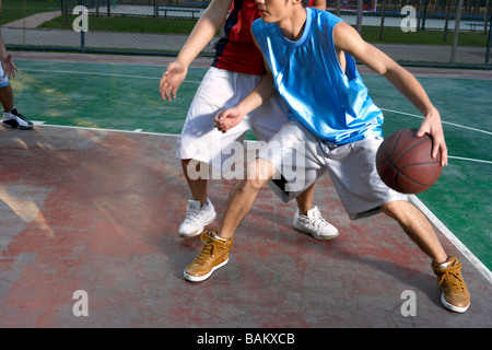 Young Men Playing Basketball Stock Photo