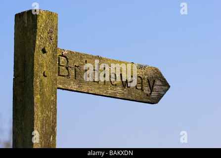 Wooden public Bridleway signpost against blue sky Kent, England Stock Photo