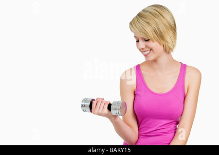 A teenage girl using dumbbells Stock Photo