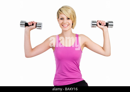 A teenage girl using dumbbells Stock Photo