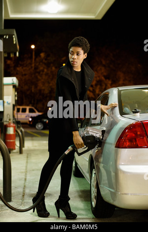 Woman at gas station Stock Photo