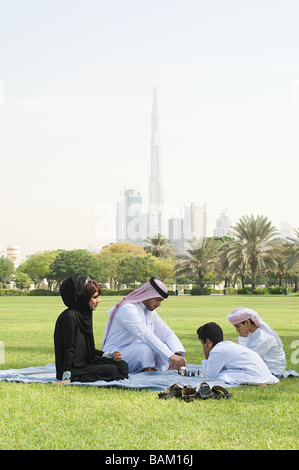 A family sat in a park playing chess