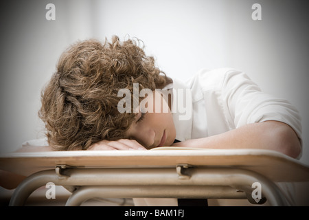 Boy asleep in classroom Stock Photo