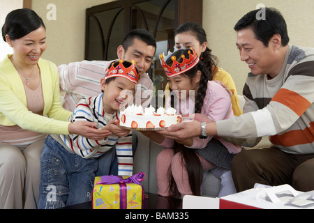 Children Looking At Birthday Cake Stock Photo