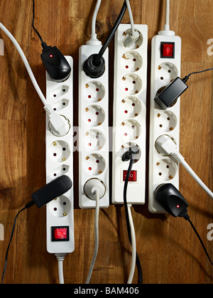 Electrical plugs on a wooden floor Stock Photo