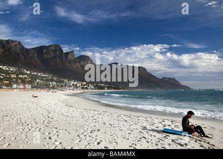 Surfer on Camps Bay beach, Cape Town, South Africa Stock Photo