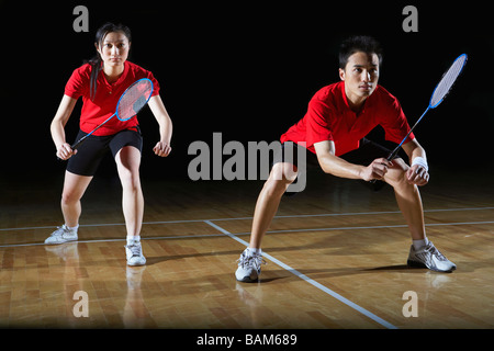 Man And Woman In Action Playing Badminton Stock Photo
