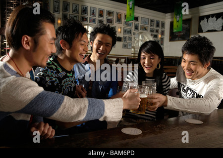 Happy Young People Toasting In A Bar Stock Photo