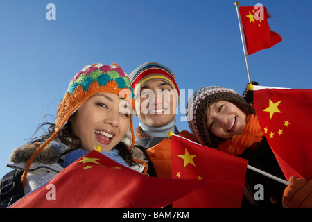 Young People Waving Flags On The Great Wall Of China Stock Photo
