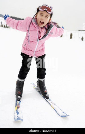 Girl Skiing Down Slope Stock Photo