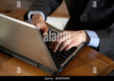 Man Typing On Laptop Computer Stock Photo