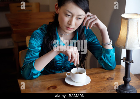 Woman Drinking Coffee Looking Contemplative Stock Photo