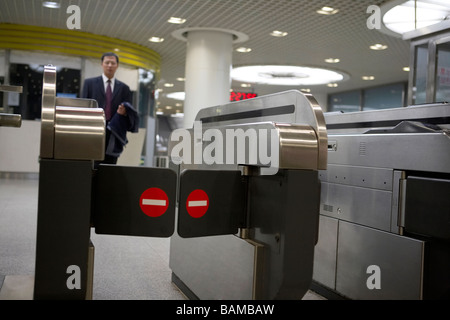 A Man Approaching The Ticket Gates At A Subway Station Stock Photo