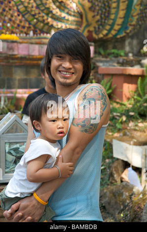 A tattooed man and his child Doi Suthep Chiang Mai Northern Thailand Stock Photo