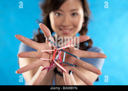 Young Women Making Cats Cradle Stock Photo