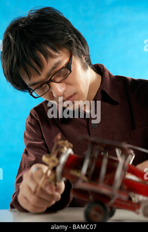 Man Watching A Red Toy Aeroplane Stock Photo