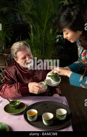 Waitress Pouring Tea For Customer Stock Photo