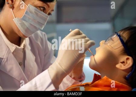 Dentist Examining Boy's Teeth Stock Photo
