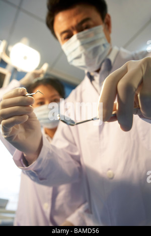 Dentist Holding Dental Equipment Stock Photo