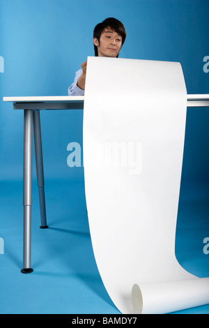 Man Reading From Big Piece Of Paper Stock Photo