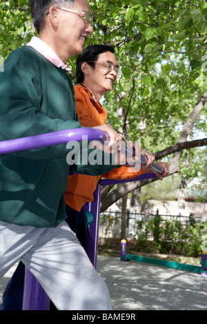 Two Senior Males Exercising In Park Stock Photo