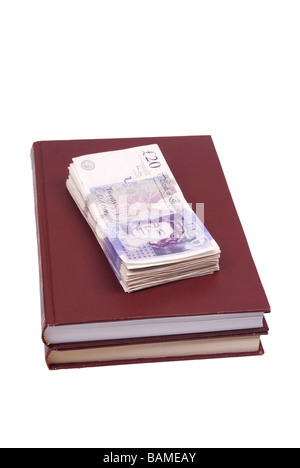 Stack of British money on top of books Stock Photo